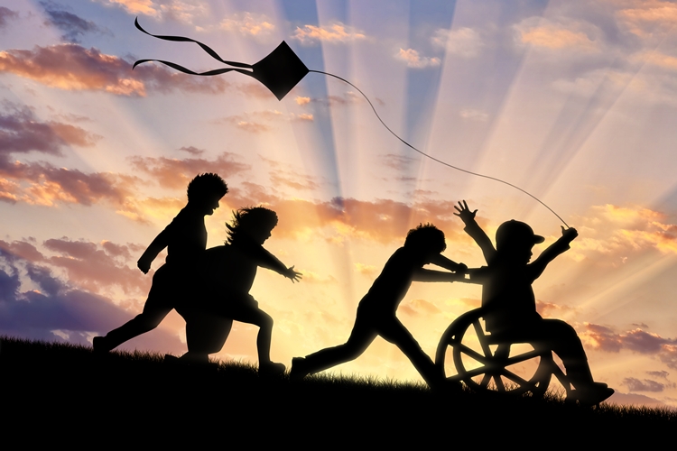 Disabled child in wheelchair with other children